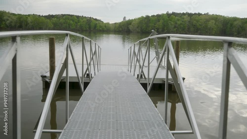 Afternoon walk on an empty boat dock on the lake while a fishing boat passes in the background. Lake Murray in South Carolina. photo