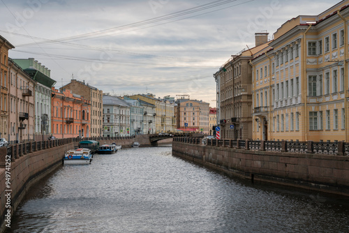 Moika River Embankment and Bolshoy Konyushenny Bridge on a cloudy spring morning, Saint Petersburg, Russia photo