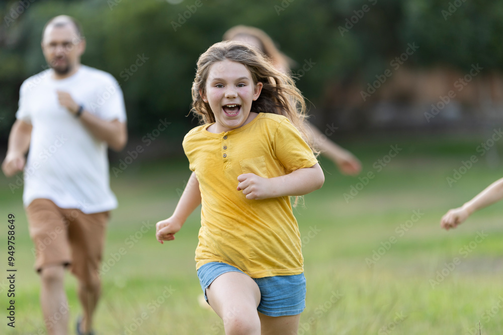Family running and playing together in the park Family running and playing together in the park