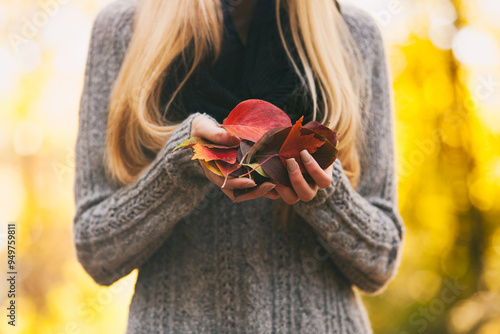 Autumn: Woman Holds Handful Of Fall Leaves photo