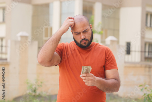 Cuadro en lienzo Confused Bald indian Man Looking at Money, Indian Rupees
