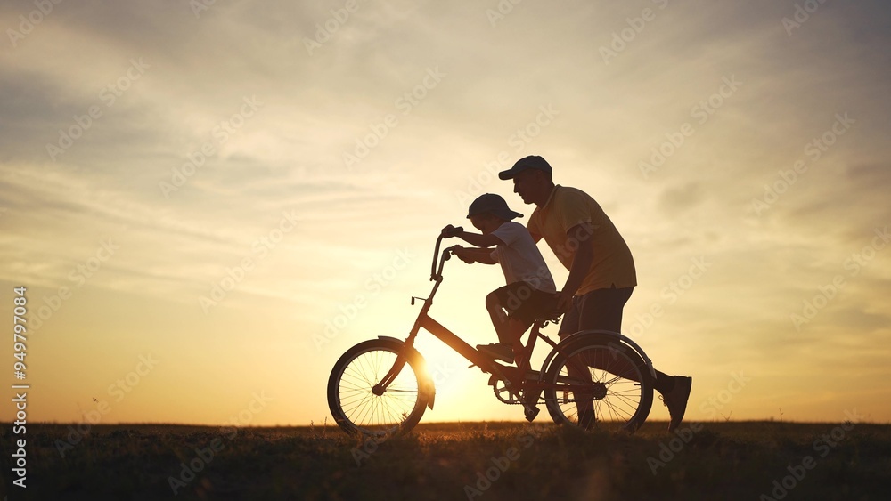 Happy family. dad teaches his son to ride bike. happy family kid dream concept. silhouette of a child riding a bicycle. silhouette of a father teaching his son to ride a lifestyle bicycle. Happy family. dad teaches his son to ride bike. happy family kid dream concept. silhouette of a child riding a bicycle. silhouette of a father teaching his son to ride a lifestyle bicycle.