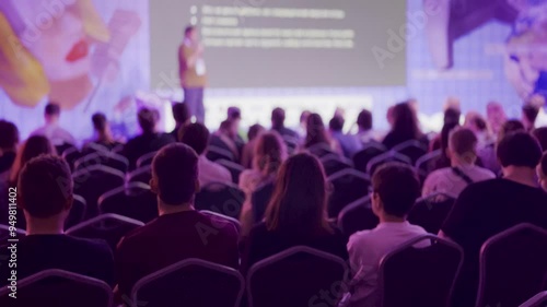 Wallpaper Mural Large audience listens attentively to a speaker on stage during a professional conference. The image highlights the atmosphere of learning and networking at the event. Torontodigital.ca