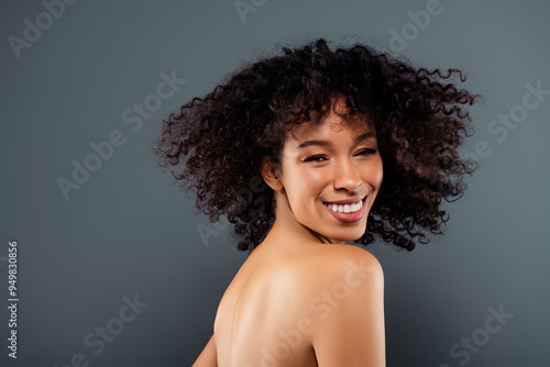 Photo of carefree cute girl naked shoulders enjoying haircare procedures isolated blue color background