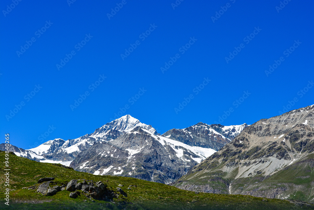 Swiss Alps peaks and ridges covered in snow in Summer. Swiss Alps peaks and ridges covered in snow in Summer.