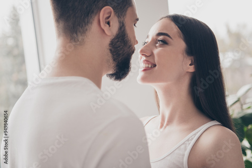 Photo of happy young couple move new place enjoy live together look eyes each other new apartment room light house flat indoor photo