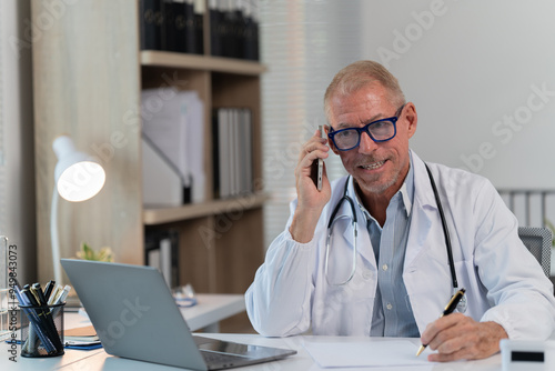 the doctor work with laptop at table in clinic. Online consultation