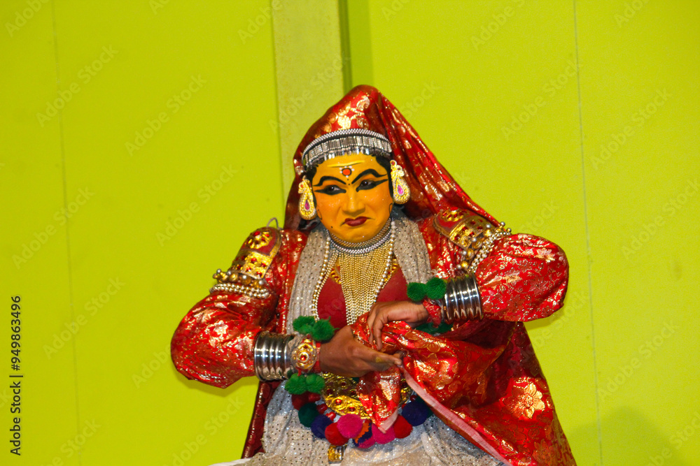MUNNAR, INDIA - FEBRUARY 10, 2016: Kathakali dancer folding hands and making face expression in Munnar of Kerala's state in India. Punarjani Traditional Village Munnar MUNNAR, INDIA - FEBRUARY 10, 2016: Kathakali dancer folding hands and making face expression in Munnar of Kerala's state in India. Punarjani Traditional Village Munnar