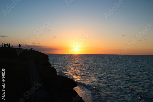 Varadero, CUBA - April 08, 2023: Varadero Beach.The famous beach of Varadero in Cuba with a calm turquoise ocean and clouds in the sky. Sunset time photo