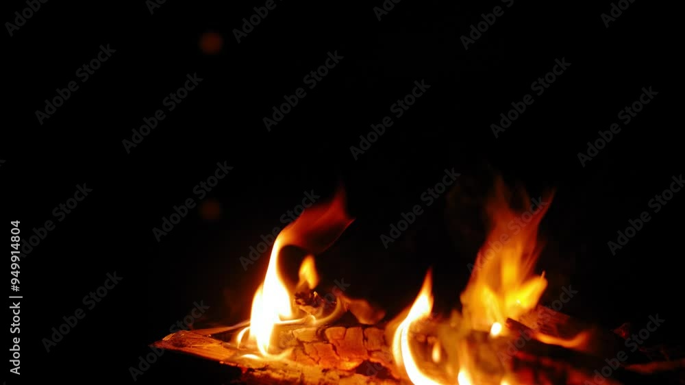Close-up of campfire against the moon reflected in the lake in the evening. Close-up of campfire against the moon reflected in the lake in the evening.