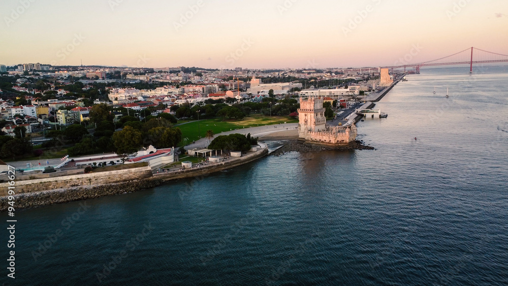 An aerial drone image of the iconic Belém Tower in Lisbon, Portugal, set against the serene backdrop of the Tagus River at sunset. Lisbon An aerial drone image of the iconic Belém Tower in Lisbon, Portugal, set against the serene backdrop of the Tagus River at sunset. Lisbon