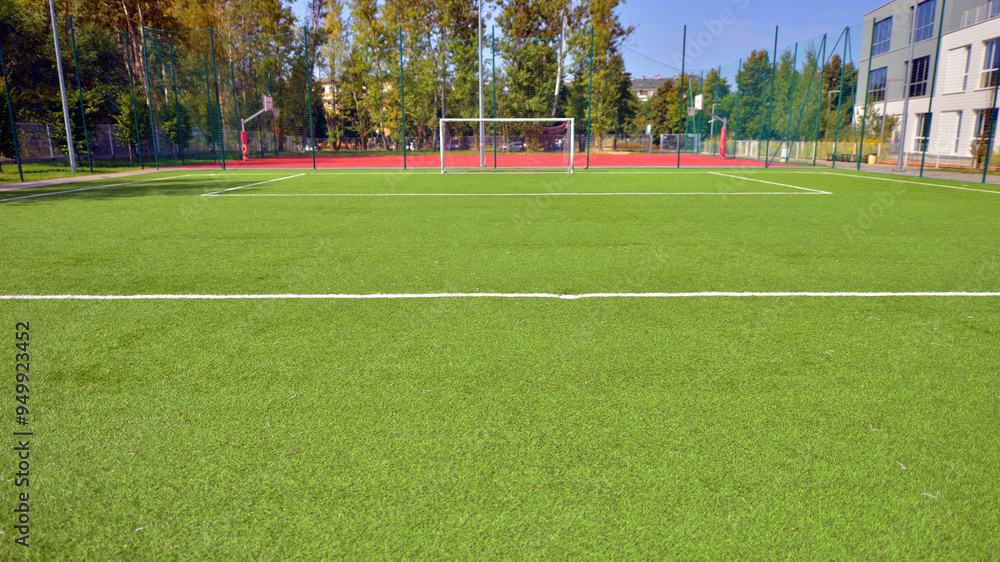 Artificial football turf with a white dividing line. Texture of Perfect green lawn on the football field. Artificial football turf with a white dividing line. Texture of Perfect green lawn on the football field.