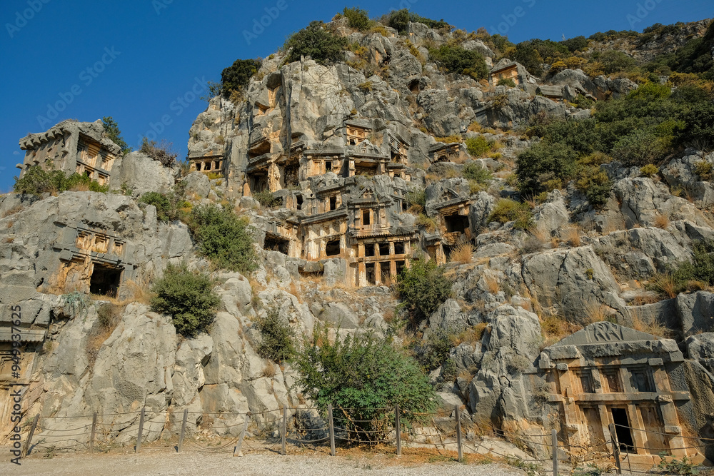 Fototapeta premium Rock-cut tombs in the ruins of Myra Ancient City in Demre, Turkey.