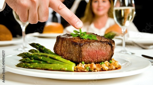 A man in formal attire enjoys a gourmet dinner featuring steak and asparagus during a romantic Valentine's Day celebration at a fine dining restaurant