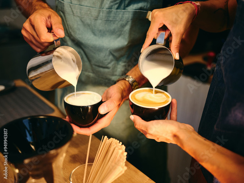 Wallpaper Mural Baristas skillfully pour steamed milk into cups at a cozy café during a sunny morning Torontodigital.ca