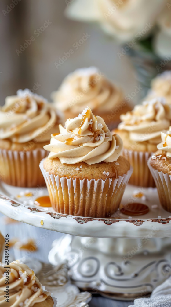 Salted caramel cupcakes with caramel frosting, sea salt flakes, and caramel drizzle on a vintage platter Salted caramel cupcakes with caramel frosting, sea salt flakes, and caramel drizzle on a vintage platter