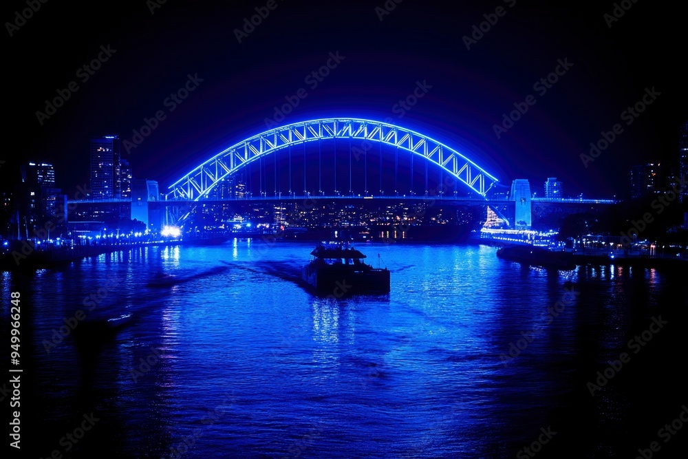Illuminated Bridge over Cityscape at Night Illuminated Bridge over Cityscape at Night