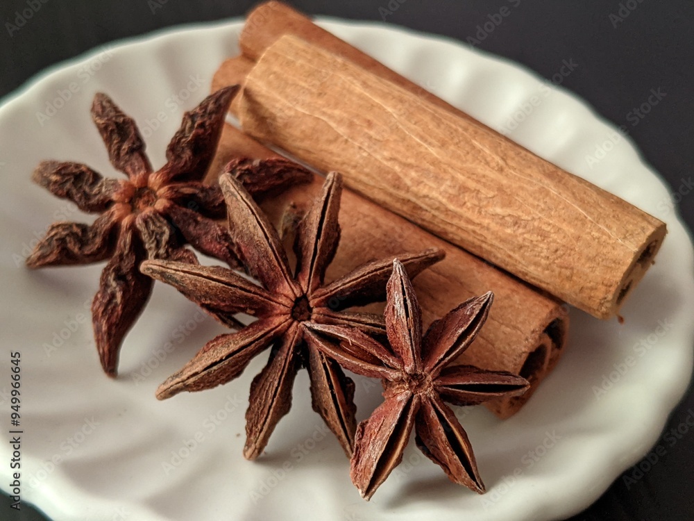 anise and cinnamon on white saucer anise and cinnamon on white saucer