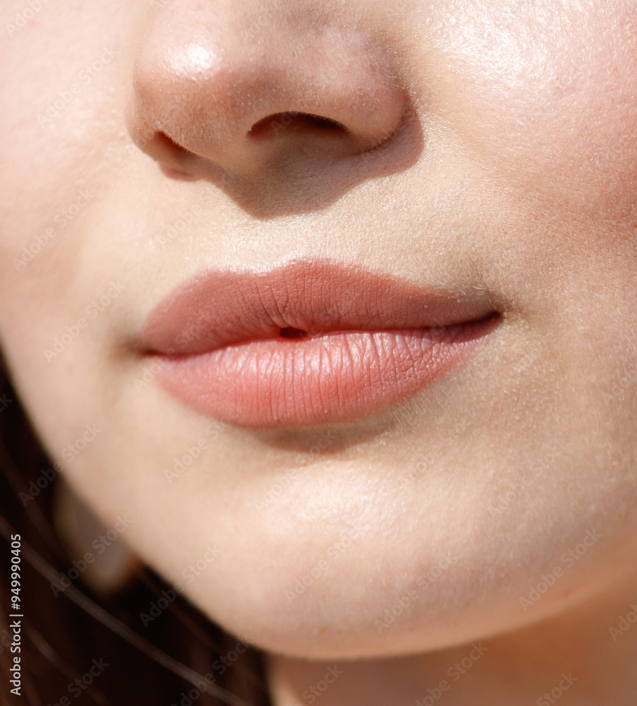 Fototapeta premium Close-up of lips on a girl's face. Macro