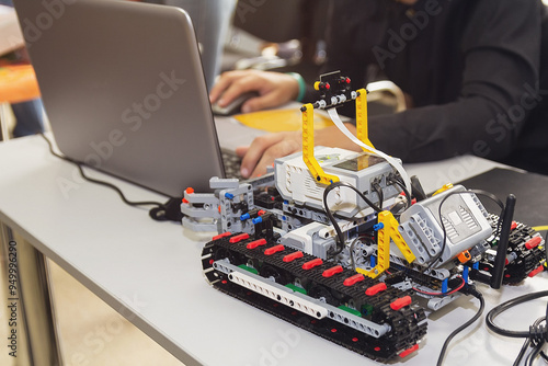 Construction workflow of electronic car with microcontroller at junior robotics club photo