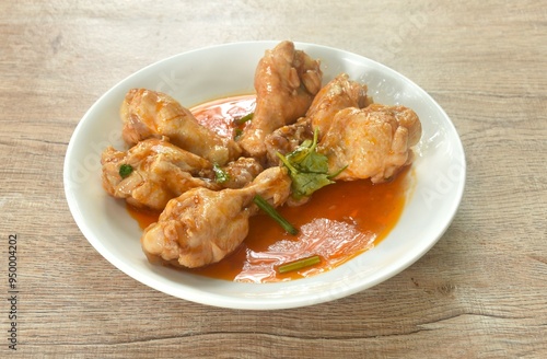 steamed chicken drumstick with sweet red gravy sauce on plate 