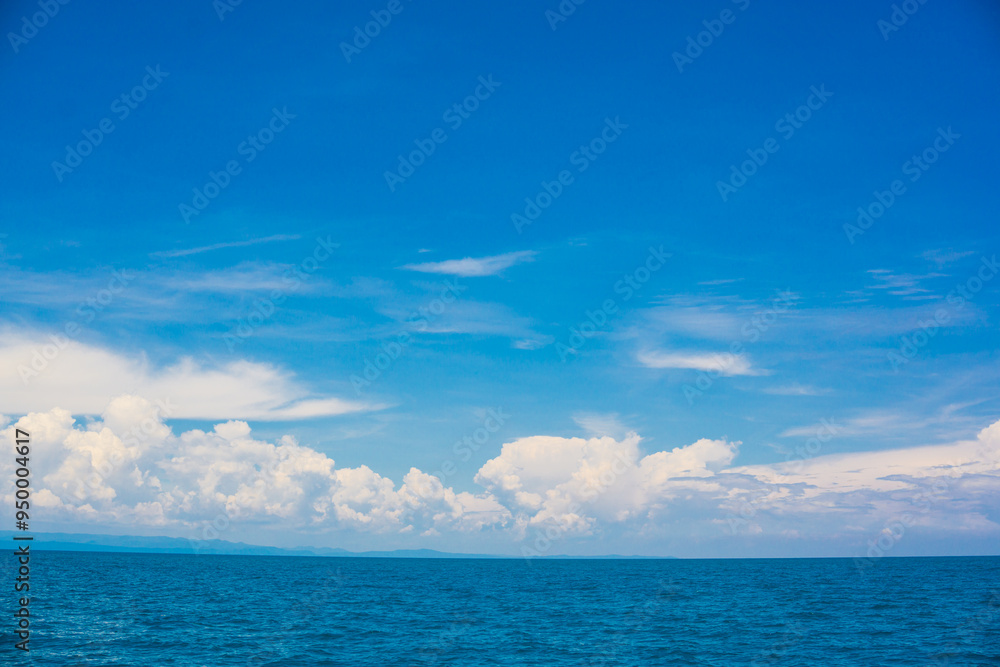 Blue sky with fluffy cloud in sea background Blue sky with fluffy cloud in sea background