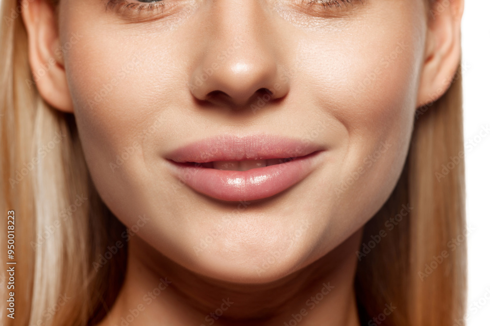 Plump female lips. Lip augmentation. Close-up cropped image of female lower face part with well-kept skin and hydrated lips. Concept of lip care, moisturizing and plumping cosmetic products Plump female lips. Lip augmentation. Close-up cropped image of female lower face part with well-kept skin and hydrated lips. Concept of lip care, moisturizing and plumping cosmetic products