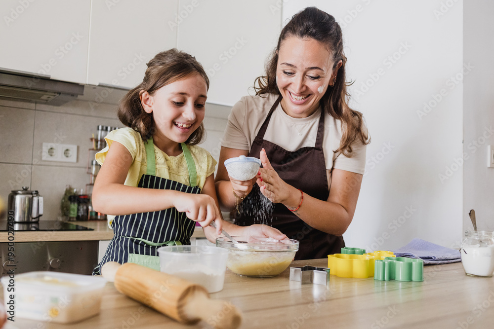 Single mother having fun while baking cookies with daughter Single mother having fun while baking cookies with daughter