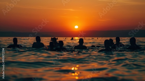 A joyful group swims happily in the ocean at sunset