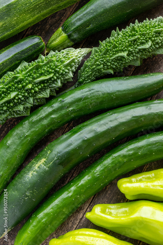 Freshly harvested green vegetables from an organic garden. Zucchini, cubanelle chilis, bitter melons, and Japanese cucumbers. photo