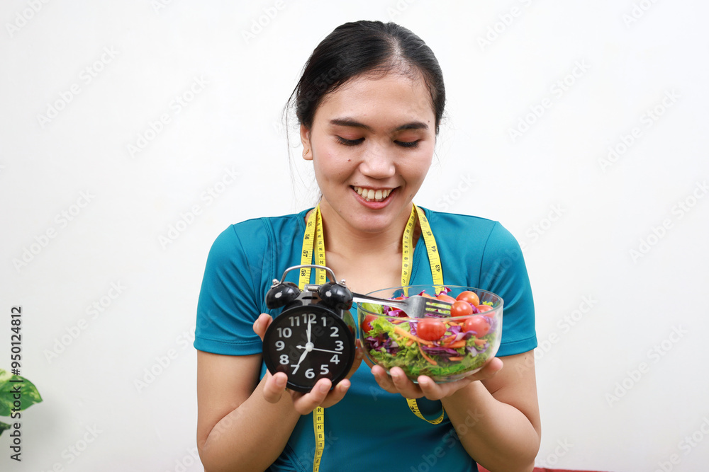 Fresh healthy salad and measuring tape around neck.Waiting for breaking the fast. Fresh healthy salad and measuring tape around neck.Waiting for breaking the fast.