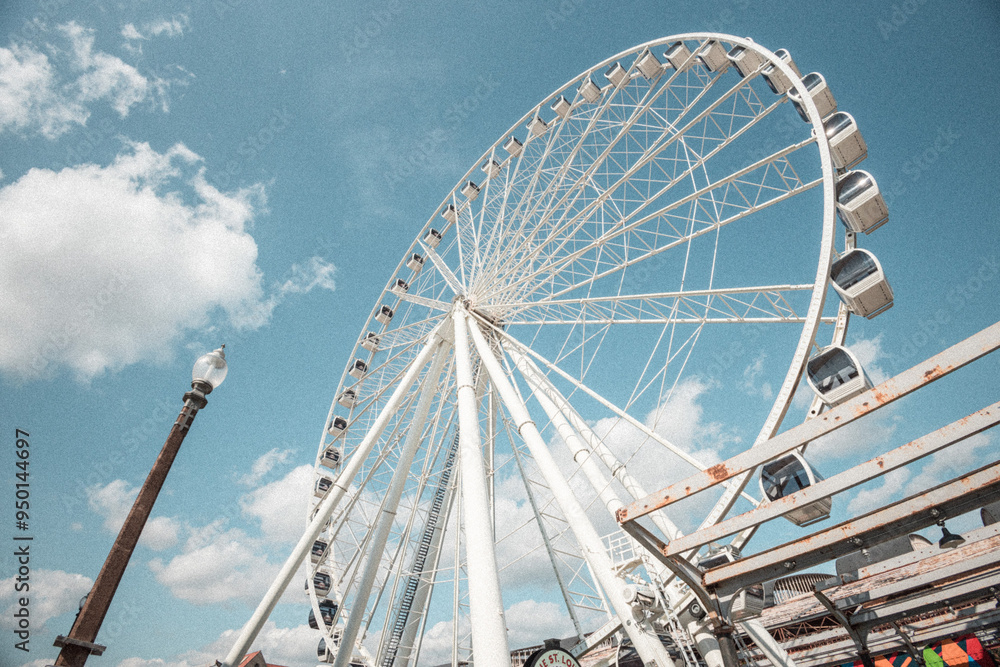 Fototapeta premium Ferris Wheel with blue cloudy sky