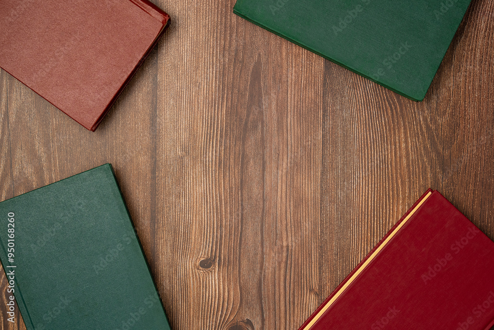 Fototapeta premium Books on wooden background from above. Flat lay, top view. Copy space