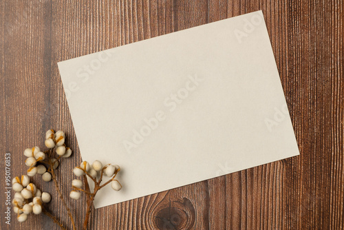 Empty white paper on wooden background from above. Space for text.