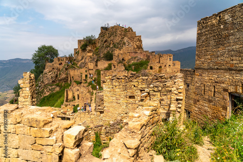 Dagestan Gamsutl. Ancient ghost town of Gamsutl old stone houses in abandoned Gamsutl mountain village in Dagestan, Abandoned etnic aul, summer landscape. photo