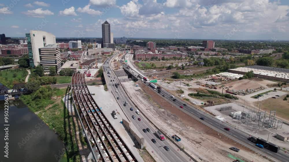 Drone aerial of new highway and multi land interstate construction coming soon and being built next to downtown and city center of Columbus, Ohio with turnpike car traffic and workers near buildings Drone aerial of new highway and multi land interstate construction coming soon and being built next to downtown and city center of Columbus, Ohio with turnpike car traffic and workers near buildings