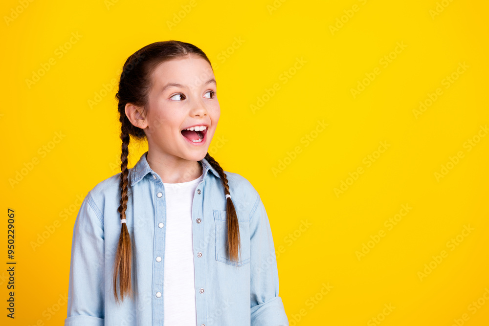 Photo of charming cute pretty girl wear trendy denim clothes look empty space isolated on yellow color background Photo of charming cute pretty girl wear trendy denim clothes look empty space isolated on yellow color background