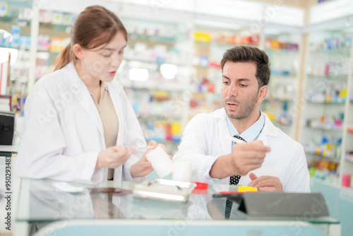 team man and woman pharmacist inspects a medication bottle, ensuring accuracy in prescription filling. pharmacists in patient safety and careful medication handling. operations in retail pharmacy.