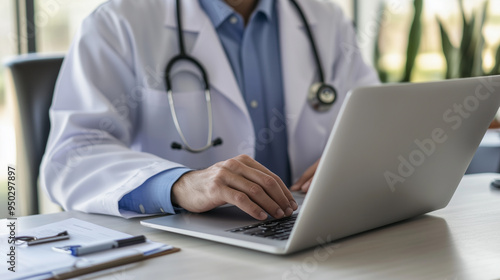 Close up shot of a doctor working intensely on a laptop in his office.