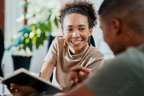 Creative, man and woman with notebook for advice, collaboration or planning ideas together in office. Business people, design team and notes for discussion, opinion or help with project internship.