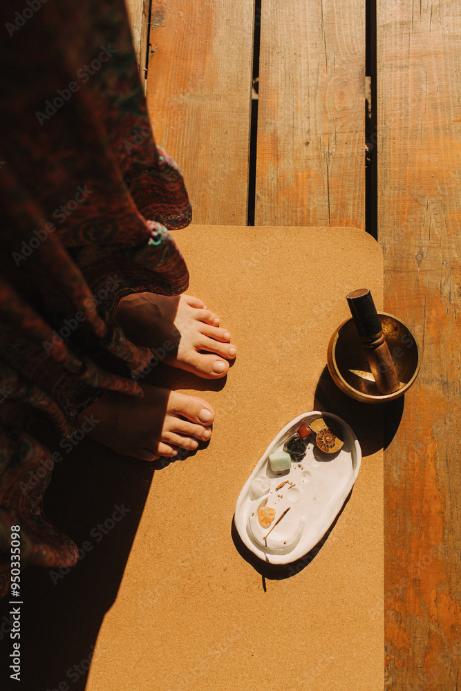 Φωτογραφία Close up of female feet with Tibetan singing bowl on yoga mat