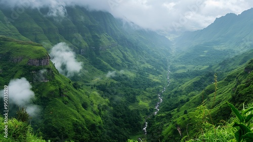 panoramic view of a lush green valley with a river