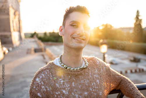 Non-binary individual smiling in golden hour light