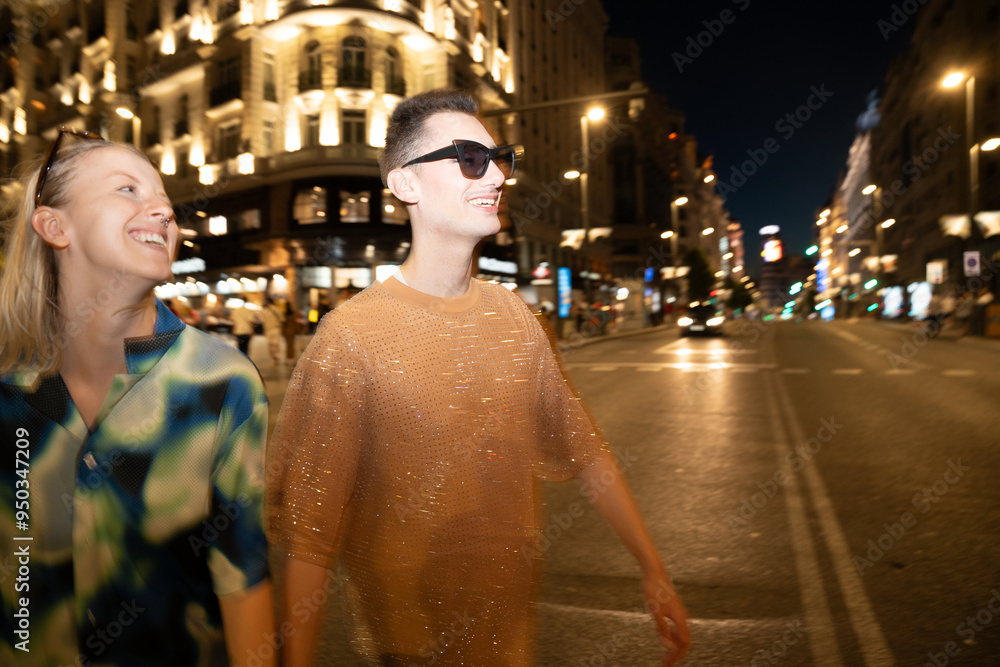 Joyful LGBTQIA+ friends exploring the city at night Joyful LGBTQIA+ friends exploring the city at night