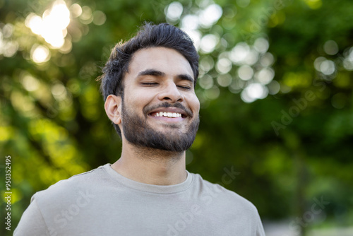 Young man enjoying serene moment outdoors with eyes closed, capturing essence of relaxation and happiness in nature