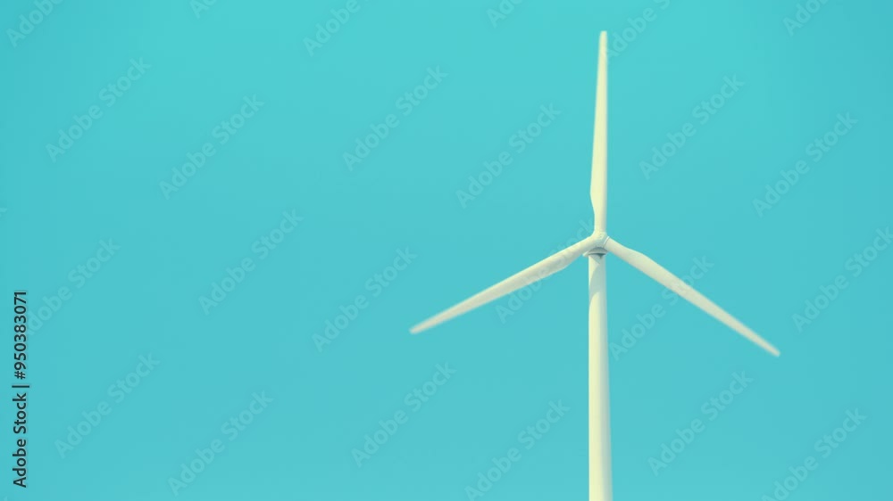 Wind turbine windmill  in rotation, power generator against blue sky. Generating electricity. Ecology, conservation and sustainable energy.
