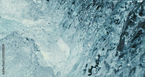 Super slow motion macro of waterfall fresh clean pure water stream is flowing down surrounded by rocks nature in natural habitat at 1000 fps.