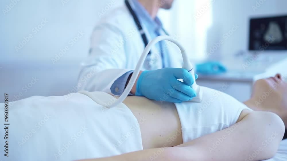 Doctor man, wearing blue medical gloves, is using ultrasound machine to examine internal organs of a patient woman. Female mammary gland health. Medicine concept Doctor man, wearing blue medical gloves, is using ultrasound machine to examine internal organs of a patient woman. Female mammary gland health. Medicine concept