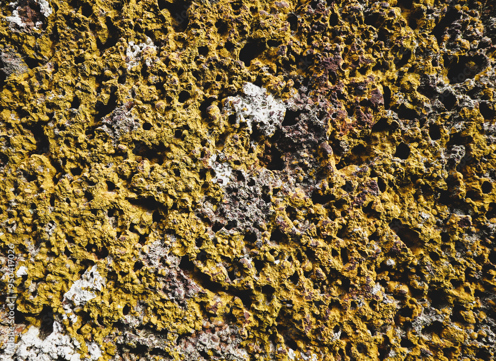 Old yellow stone wall with many hole for abstract seamless background and texture. beautiful patterns, space for work, close up. Old yellow stone wall with many hole for abstract seamless background and texture. beautiful patterns, space for work, close up.