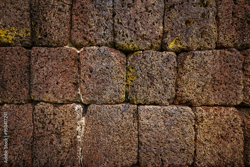 Empty old red grain stone brick wall made with antique blocks for abstract seamless background and texture. beautiful patterns, space for work, close up. photo